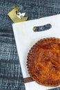 Epiphany Twelfth Night cake french galette des rois made of puff pastry, slice apart with the charm inside, on baking