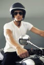 The epitome of cool. A handsome young man sitting on his motorcycle. Royalty Free Stock Photo