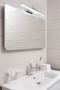 Epmty minimalistic interior background, bathroom of modern apartment, closeup of mirror, tap and basin in light colors
