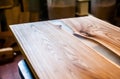 Epoxy-painted solid wood table top close-up in a carpentry workshop. Wood texture