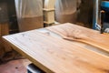 Epoxy-painted solid wood table top close-up in a carpentry workshop. Wood texture