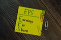 EPS - Earnings Per Share write on sticky notes isolated on Wooden Table Royalty Free Stock Photo