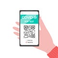 Hand holding smartphone with covid-19 PCR test. Electronic results with QR code. Health passport about coronavirus antibodies