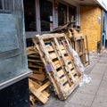 Empty Used Wooden Pallets Stored Outside A Closed Retail Shop During Coronavirus Covid-19 Lockdown