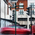 Speeding Car Passing Traffic Lights In A Town Centre