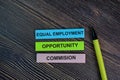 Equal Employment Opportunity Commision write on sticky notes isolated on Wooden Table