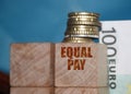 Equal pay words on wooden blocks. Income differences between men and women concept