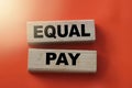 Equal pay words on wooden blocks. No Income differences concept