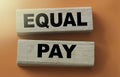 Equal pay words on wooden blocks. No Income differences concept