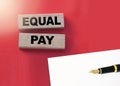 Equal pay words on wooden blocks. No Income differences concept