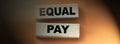 Equal pay words on wooden blocks. No Income differences concept