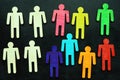 Equality and diversity concept. Multi-colored figurines on a blackboard. Royalty Free Stock Photo