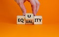 Equality or equity symbol. Businessman turns a cube and changs the word `equality` to `equity`. Beautiful orange background.