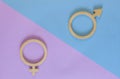 Equality between men and women. Symbols of a man and a woman made of plywood on paper on blue and pink background