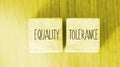 Equality tolerance words written on wood blocks. Equal rights inclusion social and business concept
