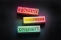 Equality transparency diversity words on wooden blocks in colorful red yellow green lights. Equality diversity concept by gender,