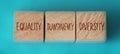 Equality transparency diversity words written on wooden cubes on aquamarine background. Equal rights social concept