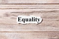 Equality of the word on paper. concept. Words of Equality on a wooden background