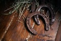 Equesrtian background. Lucky old horseshoes laying at wooden background