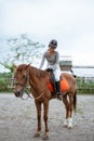 Equestrian athletes ride horses and stroke horses after competing