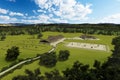 Equestrian center exterior with horses in pasture and paddock. 3D illustration Royalty Free Stock Photo