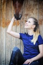 Equestrian girl and horse in stable Royalty Free Stock Photo