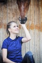 Equestrian girl and horse in stable Royalty Free Stock Photo