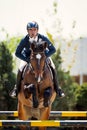 Equestrian Horse Rider Jumping. Picture showing a competitor performing in show jumping competition Royalty Free Stock Photo