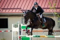 Equestrian Horse Rider Jumping.Picture showing a competitor performing in show jumping competition Royalty Free Stock Photo