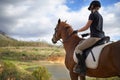 Equestrian, horse and woman riding in nature on adventure and journey in countryside. Ranch, animal and rider outdoor Royalty Free Stock Photo