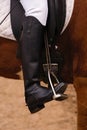 Equestrian leg in stirrup, riding attire, close-up