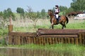 Equestrian sport. Cross-coutry. Woman on horse is Drop fence in Water jump