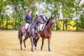 Equestrian sport dressage, walkthrough - two young girls in jockey clothes are sitting on a horse