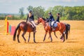 Equestrian sport dressage, walkthrough - young girls in jockey clothes sit on a horse