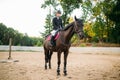 Equestrian sport, young woman sitting on horse Royalty Free Stock Photo