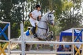 Equestrian sport. Young girl jumping over obstacle Royalty Free Stock Photo