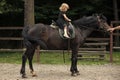 Equine therapy. Girl ride on horse on summer day