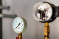 The equipment of the boiler-house, - valves, tubes, pressure gauges, thermometer. Close up of manometer, pipe, flow meter, water Royalty Free Stock Photo