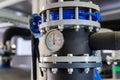 The equipment of the boiler-house, valves, tubes, pressure gauges, thermometer. Close up of manometer, pipe, flow meter, water Royalty Free Stock Photo