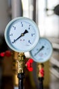 The equipment of the boiler-house, - valves, tubes, pressure gauges, thermometer. Close up of manometer, pipe, flow meter, water Royalty Free Stock Photo