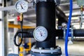 The equipment of the boiler-house, valves, tubes, pressure gauges, thermometer. Close up of manometer, pipe, flow meter, water Royalty Free Stock Photo