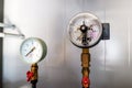 The equipment of the boiler-house, - valves, tubes, pressure gauges, thermometer. Close up of manometer, pipe, flow meter, water