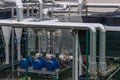 Equipment, cables and pipelines outside a modern cheese factory in France, close-up