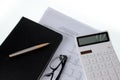 Equipment on the desk, calculator, pen, chart. Royalty Free Stock Photo