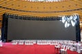 Equipment dining table and big screen in large indoor banquet hall Royalty Free Stock Photo
