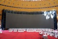 Equipment dining table and big screen in large indoor banquet hall Royalty Free Stock Photo