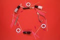 Equipment for eyelash extensions on a red background.