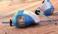 Equipment fencing mask and foil resting on the ground after the