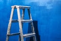 Equipment, after painting the walls of a room. Blue wall. Work at home. Detail of a staircase, in the room. Blue shades