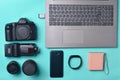 Equipment photographer, laptop, smartphone, smart watch, power bank, on a blue background. Freelance concept, gadgets for work